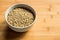 White ceramic bowl of green uncooked lentils