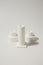 White ceramic candles stand on white background