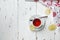 White ceramic cup with tea on a saucer. Christmas decor on a wooden background