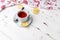 White ceramic cup with tea on a saucer. Christmas decor on a wooden background