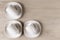 White ceramic cups and plates on wooden background, image