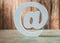 White ceramic email symbol on vintage wood background