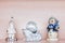 White ceramic figurine of santa claus, snowman in blue clothes and small disco xmas ball, copy space