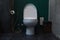 White ceramic flush toilet bowl in bathroom with toilet paper sanitary bag, bidet spray shower health faucet and rubbish bin on tr