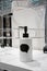 White ceramic lotion bottle dispenser with black speech balloon label standing