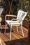 White chair, modern design on a wooden terrace. Sun, rest and solitude with yourself