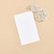 White chair and round table on beige background top view. White empty paper blank in sunshine with hard shadow. Cafe, restaurant,