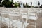 White chairs on the roof. Concert hall. Many white wooden chairs