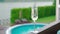 White champagne or prosecco glass against poolside at luxury resort hotel during vacation Close-up. Refreshing alcohol drink.