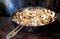 White champignon mushroom agaricus fried in frying pan on an open fire during travelling, cooking ingredients for soup, vegetarian