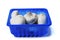 White champignon mushrooms in a blue plastic tray on isolated background. Farmed product for sale in a shop or market. Agriculture