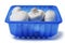 White champignon mushrooms in a blue plastic tray on isolated background. Farmed product for sale in a shop or market. Agriculture