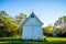 White chapel building at sunset on wooded plantation