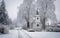 White chapel under snowy trees in a small village in winter