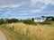 White charming house in field at French