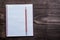 White checked copybook with red pencil on pine