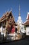 White chedi and ornate pagoda in the grounds of Wat Klang Wiang