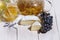 White cheese brie or camembert. Gourmet appetizer cheese plate with white cheese, honey, honeycomb, black grapes and