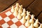 White chess on a chessboard on a wooden table. Chess game concept