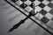 White chess king on the chessboard with shadows. Black and white photo of chess team