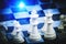 White chess pieces chessboard with bright blue light
