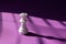 White chess queen on a purple background. Abstract background. Chess piece