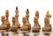 White chessmen on wooden chessboard
