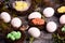 White chicken eggs and bird nests with colored eggs decorated with forest mosses and plants