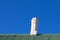 White chimney blue sky green roof