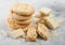 White chocolate biscuit cookies with chocolate blocks and curls on light kitchen table background