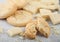 White chocolate biscuit cookies with chocolate blocks and curls on light kitchen table background