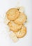 White chocolate biscuit cookies with chocolate blocks and curls on white background