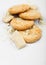 White chocolate biscuit cookies with chocolate blocks and curls on white background