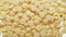 White chocolate chips falling on transparent background, bottom view.