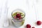 White chocolate cream mousse with matcha, avocado, pistachio, fresh raspberries - healthy vegan dairy free, gluten free