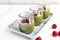 White chocolate cream mousse with matcha, avocado, pistachio, fresh raspberries - healthy vegan dairy free, gluten free