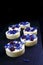 White chocolate pralines with blue knapweed petals and dried cranberries