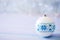 White Christmas ball with blue winter Ukrainian ornament on light bokeh background