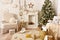 White Christmas interior. Beautiful Christmas tree, armchair, baskets, gifts, skates, stairs and other decoration