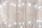 White Christmas lights double border over light gray wood