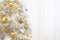 White christmas tree with gold decoration on white background