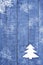 White Christmas tree made from felt on wooden, blue background. Snow flaks image. Christmas tree ornament, craft.
