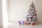 White Christmas tree with red toys new year winter gifts decor