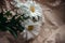 White Chrysanthemum flowers in brown craft paper on a white table. Golden-daisy bouquet on blurred background