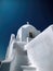 White church on the mountainside of a greek island - AI Generated