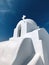 White church on the mountainside of a greek island - AI Generated
