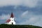 White church with red tiled roof in Iceland.