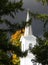 White church steeple illuminated by shaft of light