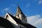 White church with steeple under repair under deep blue sky