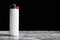 White cigarette lighter on grey table on black background with copy space